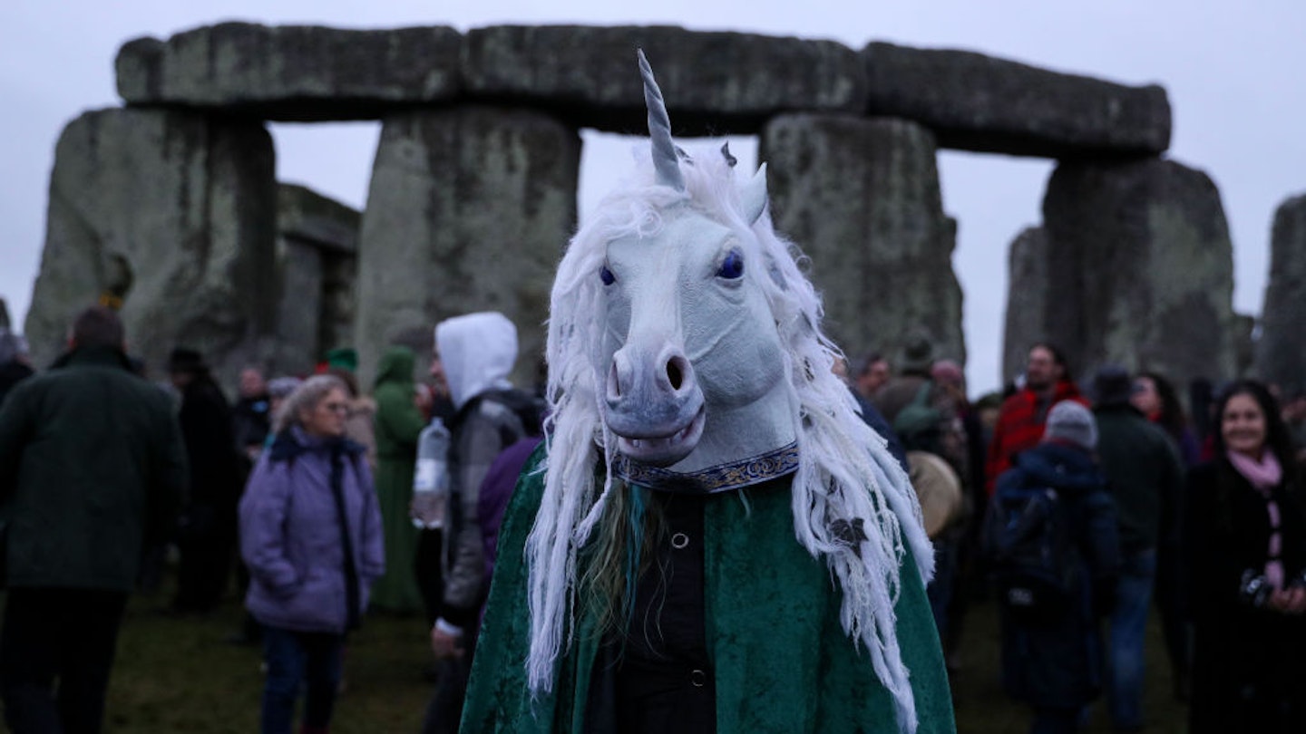 People gather at Stonehenge in Wiltshire on the winter solstice to witness the sunrise after the longest night of the year. (Photo by Andrew Matthews/PA Images via Getty Images)